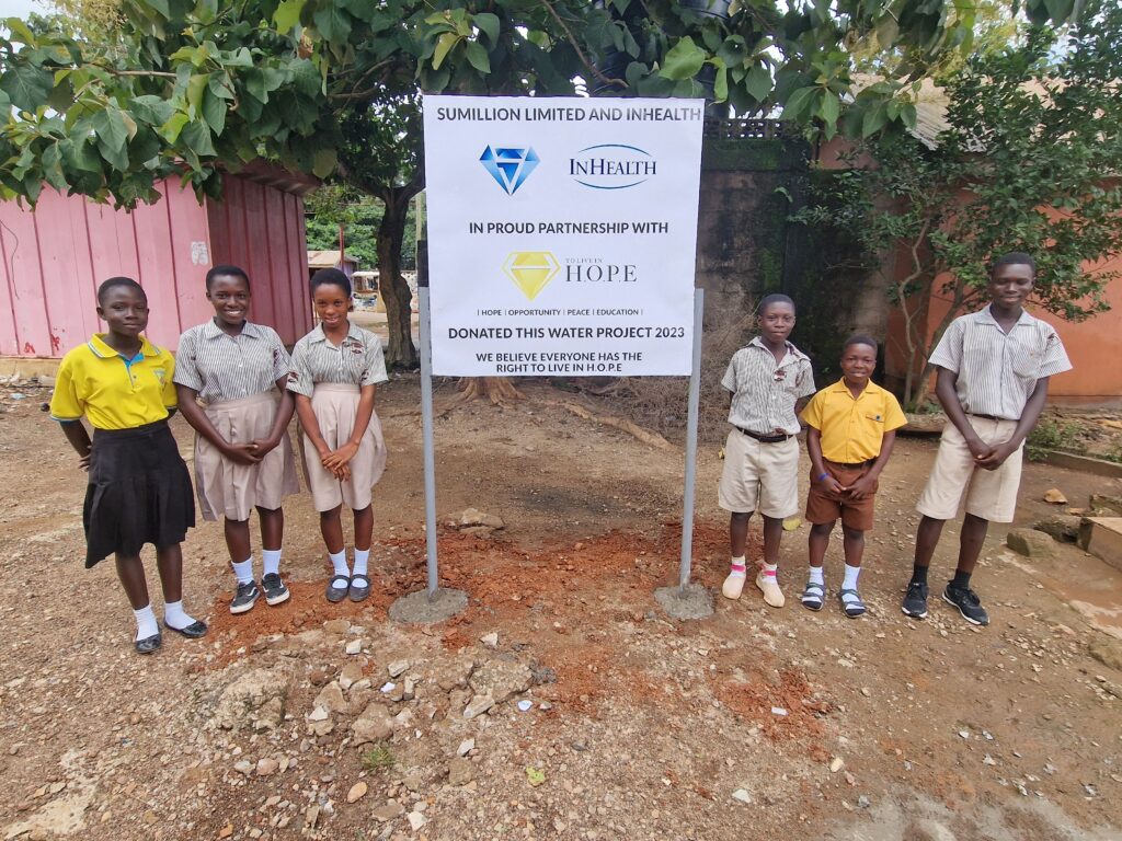 Children from Ghana standing in front of the new InHealth well